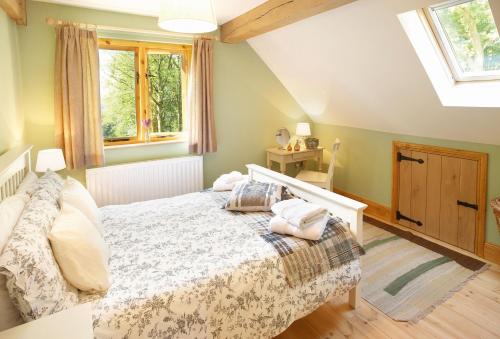 a bedroom with a bed and two windows at Deerpark Lodge in Ashby de la Zouch