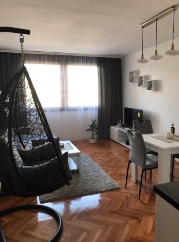 a living room with a hammock hanging from the ceiling at Apartman Snezana in Pirot