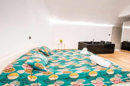 Un dormitorio con una cama grande con una manta colorida. en Basilica Suite, en Bari