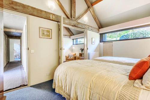 a bedroom with a large bed and a window at The Shippen in Membury