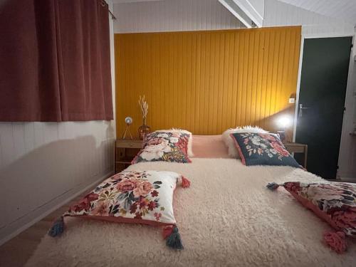 a bedroom with a large bed with pillows on it at Chalet L Atypic in Eyne