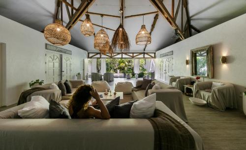 a woman sitting on a bed in a room at Buena Vida Resort and Spa in Daanbantayan