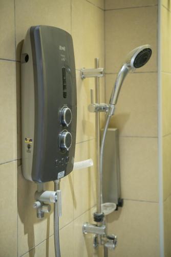 a soap dispenser on the wall of a bathroom at Sovotel @ Bandar Menjalara in Kuala Lumpur