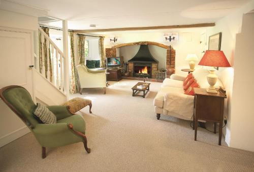 a living room with a bed and a fireplace at Magna Cottage in Ashmore
