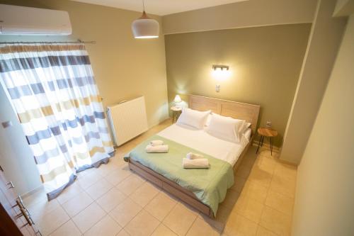 a bedroom with a bed with two towels on it at Iasonas House 85m2 in Preveza