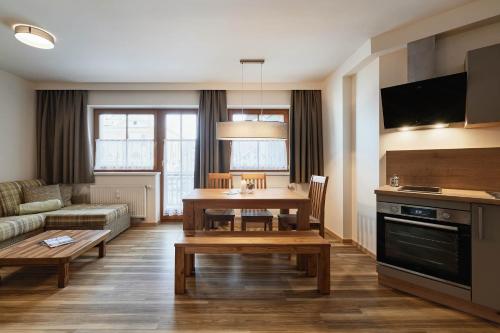 a living room with a table and a couch at Appartement Oberwirt Ferienwohnung in Ebbs