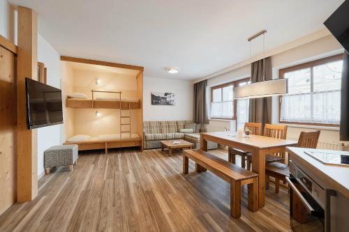 a kitchen and living room with a table and a dining room at Appartement Oberwirt Ferienwohnung in Ebbs