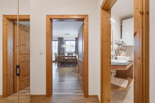 a bathroom with a glass door leading to a dining room at Appartement Oberwirt Ferienwohnung in Ebbs