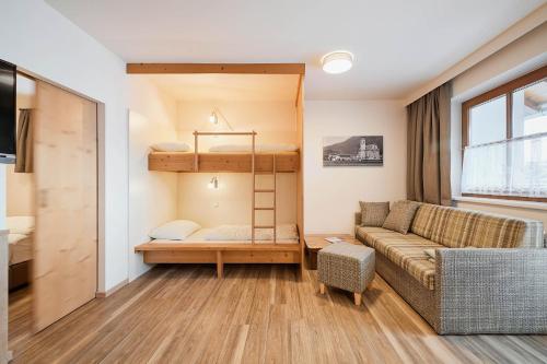 a living room with a couch and a bunk bed at Appartement Oberwirt Ferienwohnung in Ebbs