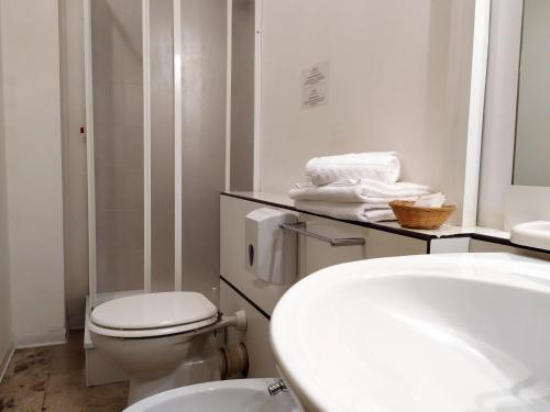 Baño blanco con aseo y lavamanos en B&B Cameracaffè Centro, en Arezzo