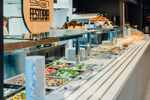 a buffet line with many different types of food at Apartamenty Collegia in Gdańsk