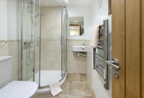 uma casa de banho com um chuveiro, um WC e um lavatório. em Wall Hills Barn em Bromyard