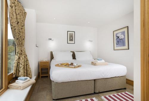 a bedroom with a bed and a window at Wall Hills Barn in Bromyard