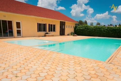 a swimming pool in front of a house at Cozy Nest Wi-Fi, Netflix call:0707070617 in Eldoret