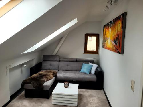 a living room with a couch in a attic at gemütliche Ferienwohnung in Burgstaedt