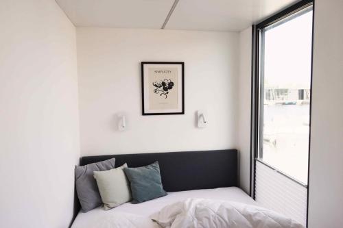 1 dormitorio con cama y ventana en Hausboot La Mare Claudia, en Weyhe