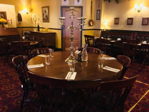 a dining room with a wooden table and chairs at Thornhill Inn in Thornhill