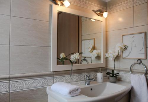 a bathroom with a sink and a mirror at Villa Kyriaki in Kalami