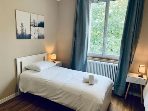 เตียงในห้องที่ Le Mimosa, Maison-Jardin dans Rennes- 2 chambres