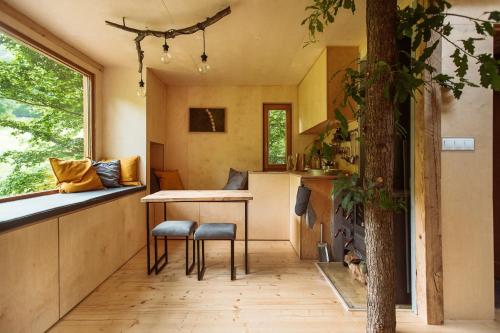 a tiny house with a kitchen and a tree at StromDom Dva Duby in Nová Baňa