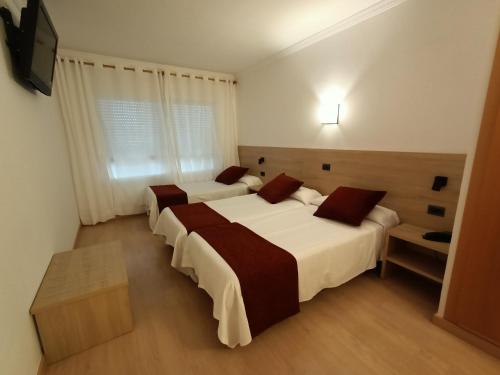 Postel nebo postele na pokoji v ubytování Hotel Vilobi