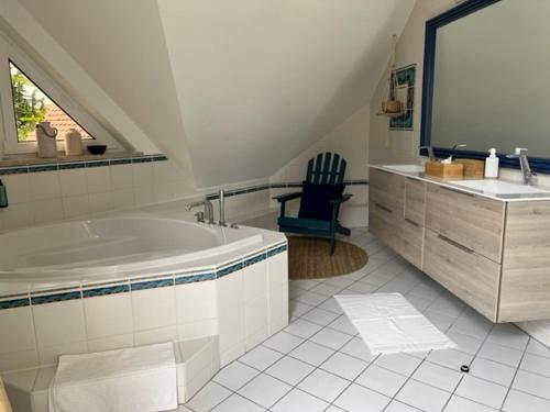 a white bathroom with a tub and a sink at Villa Margaux in Lampertheim