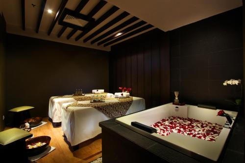 a room with a bath tub filled with red hearts at Sovereign Bali Hotel in Kuta