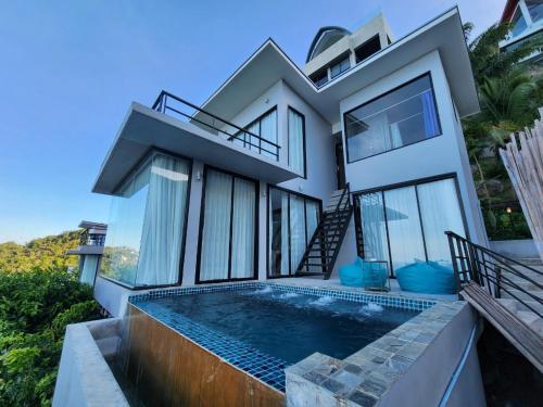 a house with a swimming pool in front of it at Scenery Samui in Koh Samui 