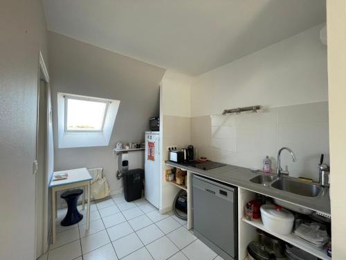 a small kitchen with a sink and a refrigerator at A deux pas de la grande plage in Quiberon