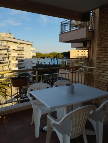 a white table and chairs on a balcony at SEAFRONT APARTMENT PINEDA BEACH in La Pineda