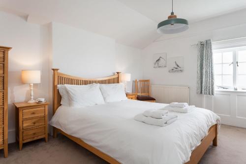 Un pat sau paturi într-o cameră la Sevenstones