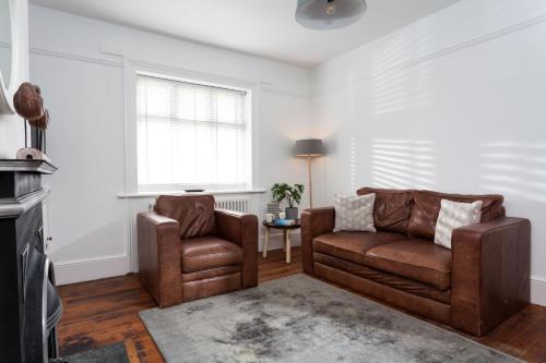 a living room with two chairs and a couch at Longships in Landewednack