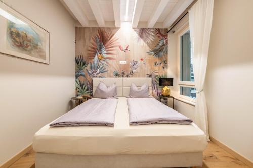 a bedroom with a large bed in a room at Cavalino Boutiquehouse in Cavaion Veronese