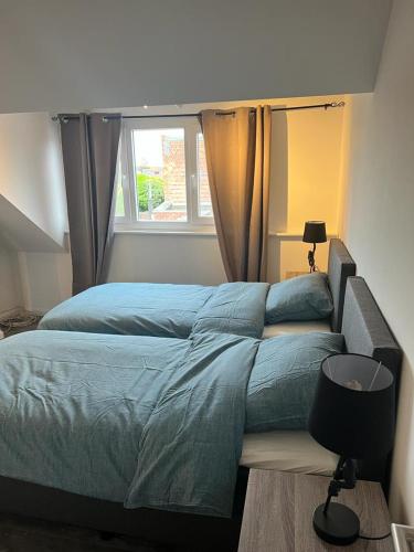 a large bed in a bedroom with a window at Happy Home Eeklo in Centre in Eeklo