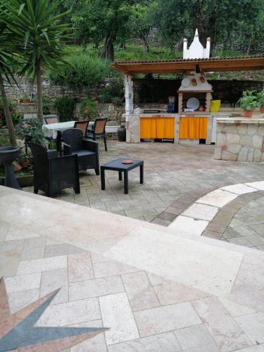 a patio with chairs and a table and a grill at La casa di Antonella in Vico del Gargano