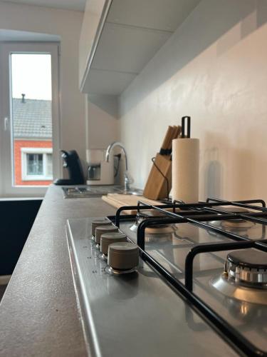 a kitchen with a stove and a counter top at Happy Home Eeklo in Centre in Eeklo