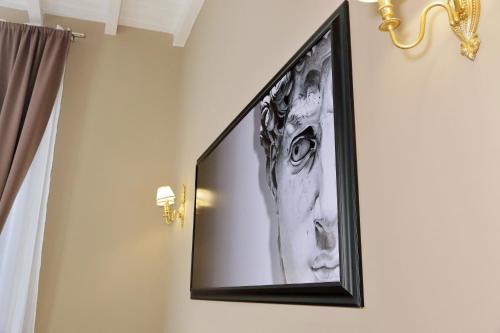 a flat screen tv hanging on a wall at Il Borgo Luxury Suites in Nettuno