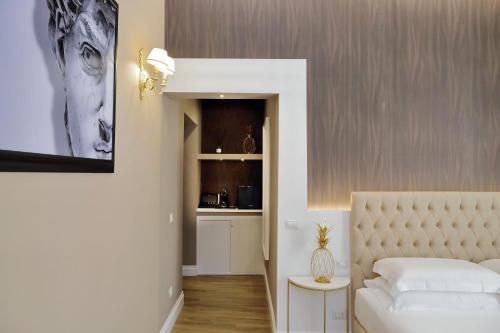 a living room with a bed and a kitchen at Il Borgo Luxury Suites in Nettuno