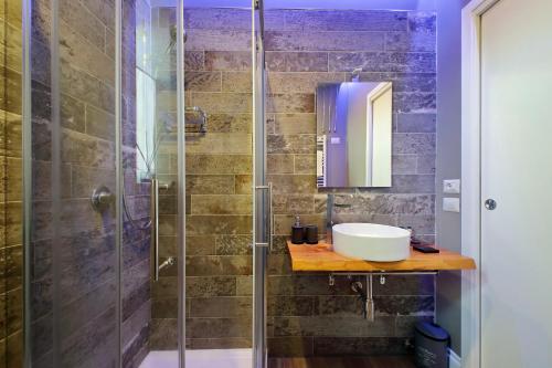 a bathroom with a sink and a shower at Il Borgo Luxury Suites in Nettuno