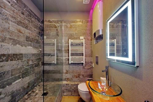 a bathroom with a glass sink and a shower at Il Borgo Luxury Suites in Nettuno
