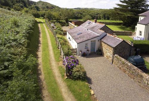 an aerial view of a house with a stone wall at The Dairy Pembrokeshire in Dinas