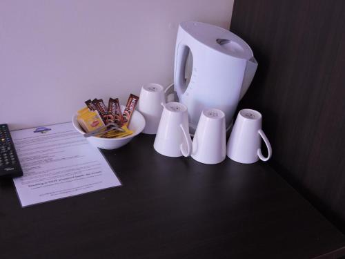 a group of white cups sitting on a table at Siesta Villa in Jindabyne