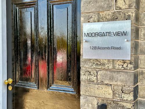 a door with a sign on the side of a building at Moorgate View - Free on street Parking in York