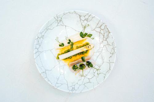 a white plate with food on a white table at Schnitzers Dahoam - Hundefreundlich in Bad Wiessee