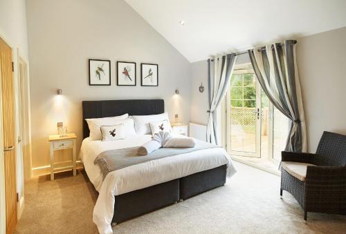 a bedroom with a large bed and a window at Campion Lodge in Chappel