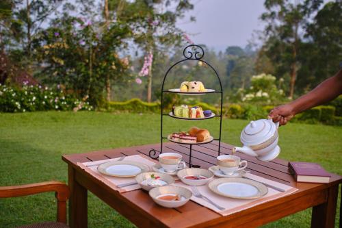 a table with a tray of food on it at Ceylon Tea Trails - Relais and Chateaux - All Inclusive in Hatton