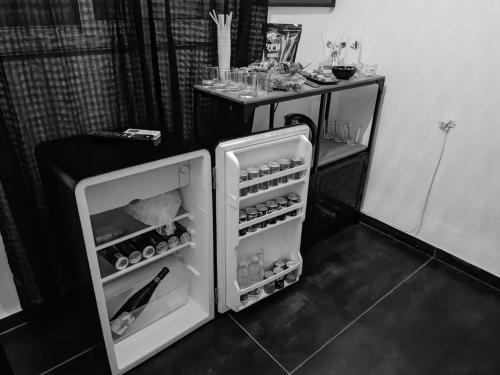 a small refrigerator with its door open in a kitchen at Fifty Shapes in Nesher