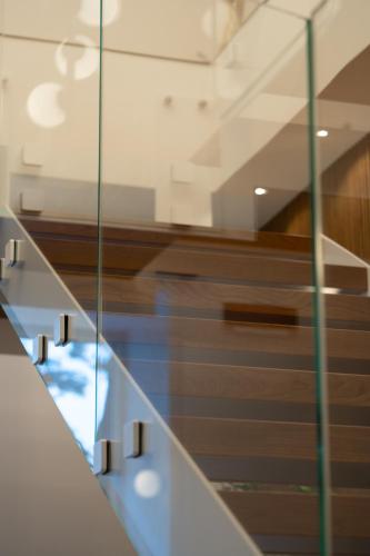 a glass staircase in a building with wood at BMC Home in Boscotrecase