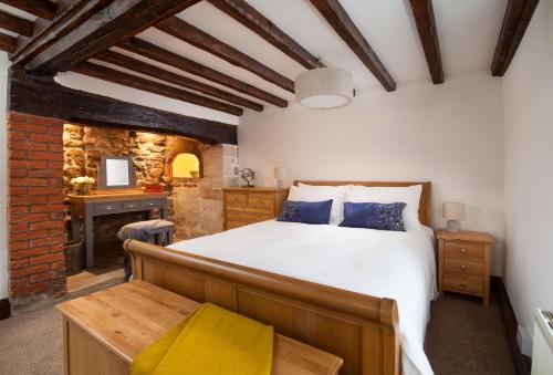 a bedroom with a large bed and a desk at Smithycroft in Combe Saint Nicholas