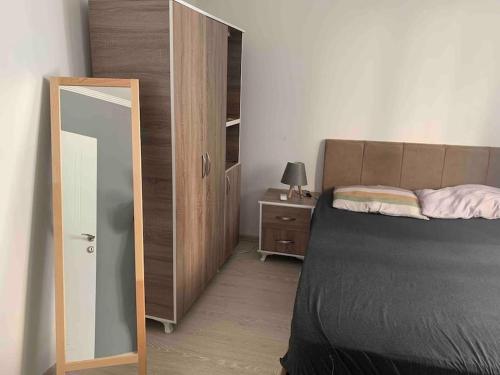 a bedroom with a bed and a mirror and a dresser at Lux apartment in Cafeler caddesi in Antalya